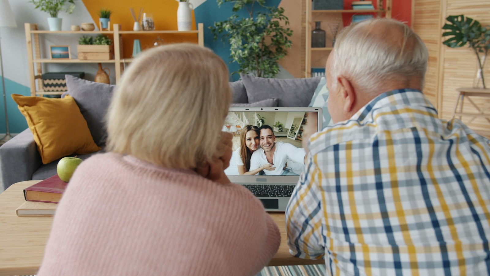 An older couple talks with family members on a video call