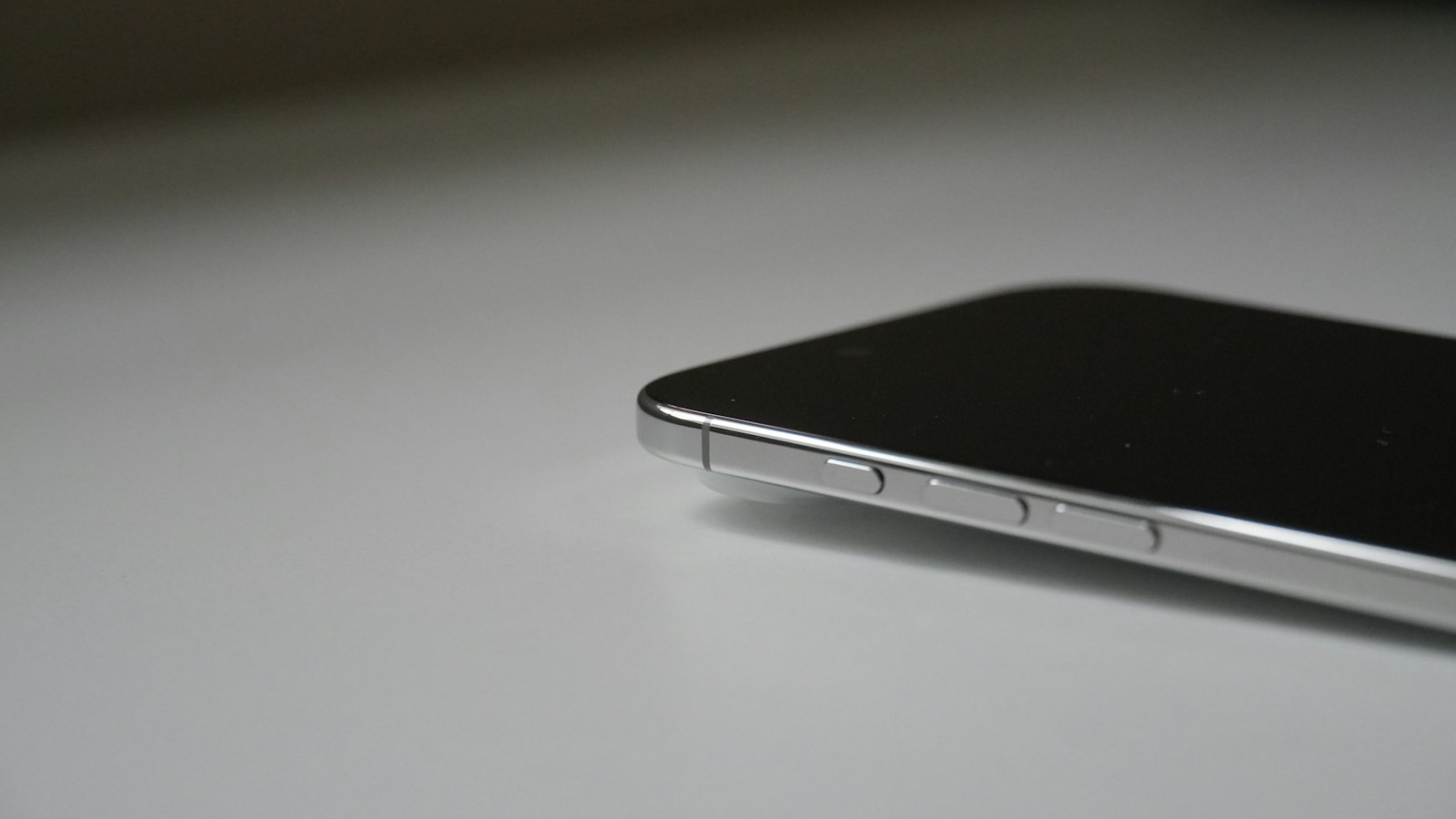 A smartphone resting face up on a light surface